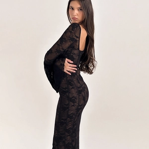 Detailed close-up of exquisite floral lace patterns on elegant black flared sleeves