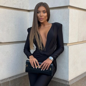 Detail of elegant black deep V-neck bodysuit with gathered waist and luxury accessories