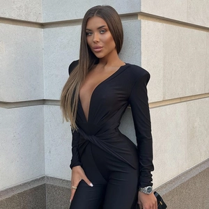 Detailed view of the deep V-neckline and twist front design on the black bodysuit