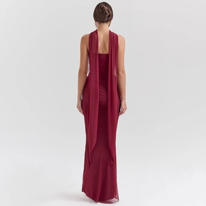 Detail view of burgundy slim fit tube dress with halter back cape and pleated texture