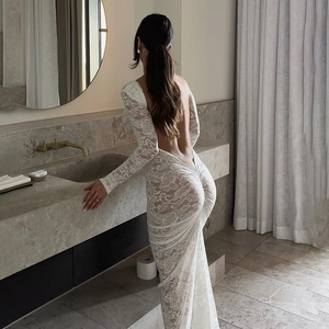 Detailed view of white lace floral embroidery on backless long sleeve maxi dress