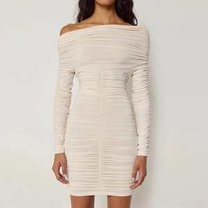 Close-up detail of the cream beige ruched fabric and texture on the slim fit mini dress