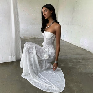 Close-up of a white lace strapless dress featuring a 3D handmade rose on the waistline