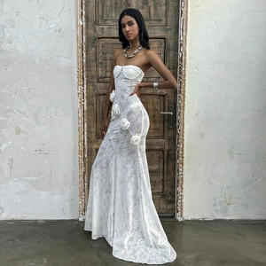 Macro detail of white lace strapless fishtail dress with 3D floral applique ornaments
