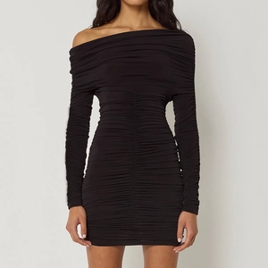 Detail of elegant black long sleeve ruched dress with asymmetric off-shoulder neckline