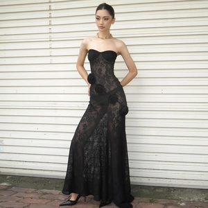 Detailed close-up of a black lace strapless gown with 3D floral appliques and a long train