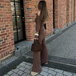 Chic coffee brown two-piece set featuring off-shoulder long sleeve top and wide leg pants
