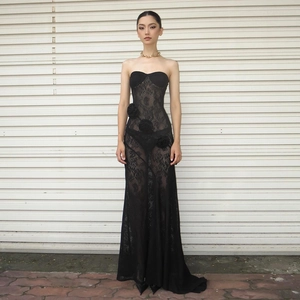 Detail of black tube maxi dress featuring 3D floral lace textures and slim-fit silhouette
