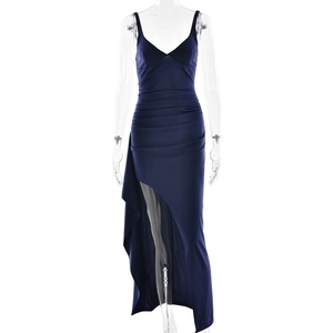 Detail of navy blue V-neck dress featuring sophisticated ruched fabric and high slit design