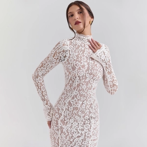 Detailed view of intricate white floral lace texture on a slim-fit evening dress sleeve