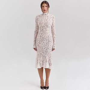 Close-up of intricate floral lace detailing on white long-sleeve slimming mermaid dress