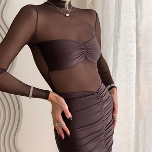 Detail of sheer mesh texture and ruched fabric on this dark brown bodycon dress