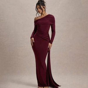 Detail of burgundy off-shoulder dress featuring asymmetrical pleats and long sleeves