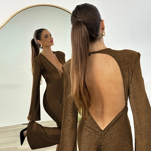 Macro shot of dark brown shimmering fabric with deep V-neck and open back jumpsuit detail