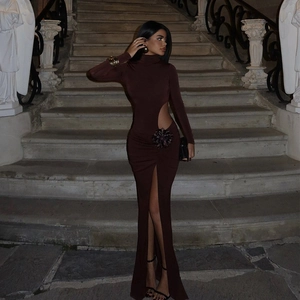 Detail of cut-out waist with large 3D floral accent on a brown long sleeve maxi dress