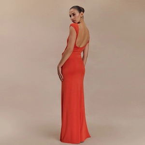 Detail view of orange-red long dress featuring deep V backless design and slim fit cut