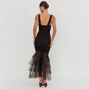 Elegant black bodycon evening dress with ruched fabric and layered fishtail hem