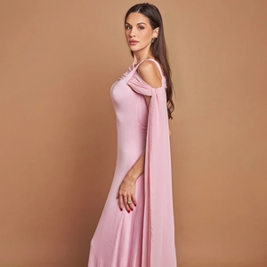 Detail of pink off-shoulder evening gown with elegant cape sleeves and fitted silhouette