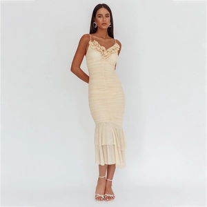 Détail d'une robe sirène champagne avec encolure fleurie et tissu en tulle plissé