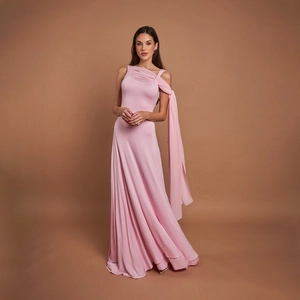 Detail of the elegant light pink evening gown showing the soft sash and fabric draping