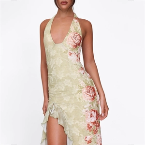 Detail of floral print maxi dress featuring halter neck design and ruffled side slit