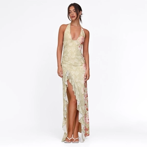 Close-up of halter floral maxi dress with high slit, ruffles, and red rose print