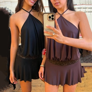 Detail of backless halter dress featuring lace patchwork and ruffled hemline in black and brown