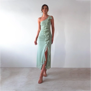 Detail of light green one shoulder maxi dress featuring ruffled trim and side high slit