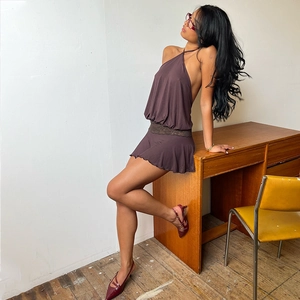 Detail of mocha halter mini dress featuring intricate lace waist panel and gathered fabric