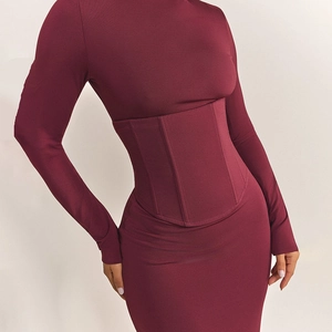 Detail of burgundy bodycon dress featuring boned corset waist and ribbed knit texture