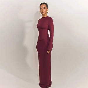 Detail of burgundy long-sleeve maxi dress featuring a corset-style waist and slim fit