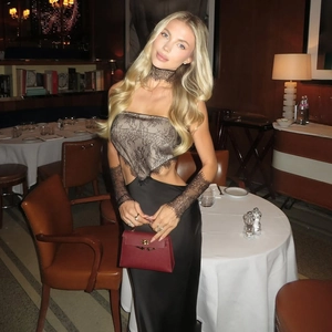 Detailed view of elegant black lace patchwork dress with matching neckband and lace gloves