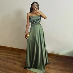 Detail of elegant sage green strapless satin maxi dress with pleated bodice and a sleek finish