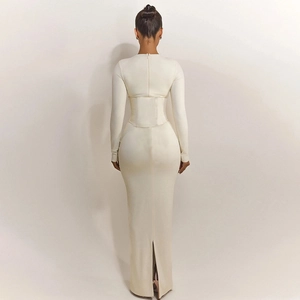 Detail of a slim fit cream long dress with corset waist and back slit design