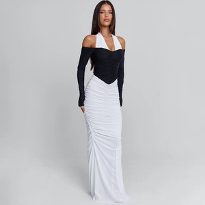 Close-up of ruched black bodice with halter neckline and long sleeves on a gown