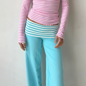 Detail der blauen High-Waist-Hose mit gestreiftem Bund für eine schlanke Passform