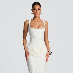 Detail of white corset evening gown featuring elegant waist draping and mesh texture