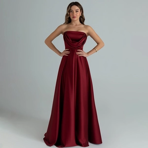 Detail of elegant wine red satin strapless evening gown with draped pleated neckline