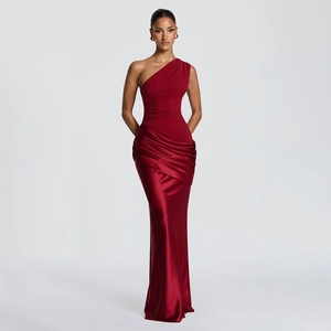 Detail of red one-shoulder evening gown featuring satin pleats and sleek mermaid silhouette