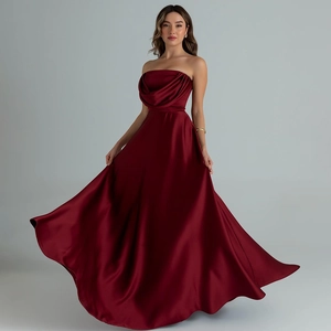 Elegant wine red satin strapless evening gown with draped neckline and flowing long skirt