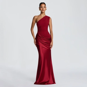 Detail of red satin mermaid dress featuring elegant ruching and one-shoulder silhouette