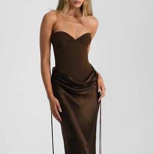 Detail of dark brown corset top and satin fishtail skirt with elegant draped pleats