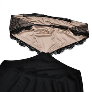 Detail of black satin dress with floral lace trim, adjustable straps, and hidden side zipper