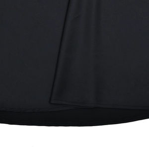Detailed macro view of the black dress hemline featuring premium multi-layer stitching
