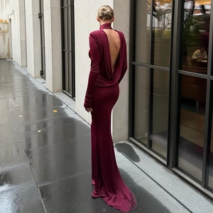 Detail of burgundy backless evening gown with high neck and elegant draped waist