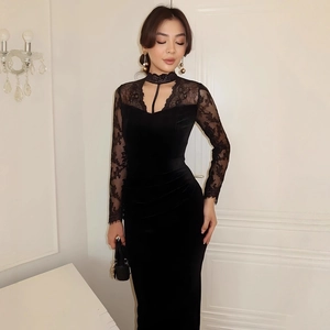 Close-up of the delicate lace neckline and sheer sleeves on a black velvet dress