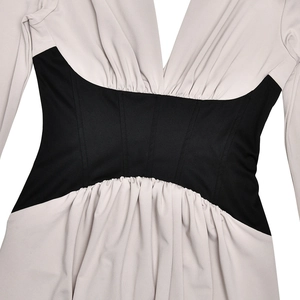 Detail of deep V-neckline and black ruched waist splicing on the bodycon dress