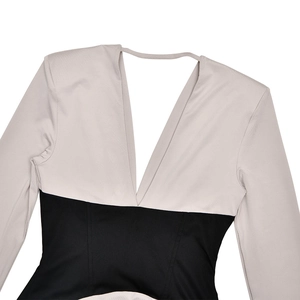 Detail of slim fit two-tone dress with deep V-neck and nude-black contrast fabric