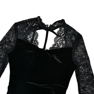 Detailed view of the lace collar and hollow-out patchwork on the black velvet dress