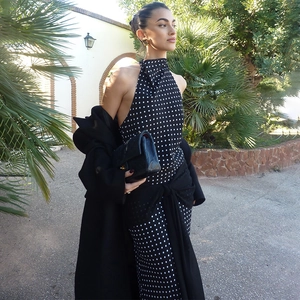 Elegant halter neck polka dot dress with backless high waist design and black coat